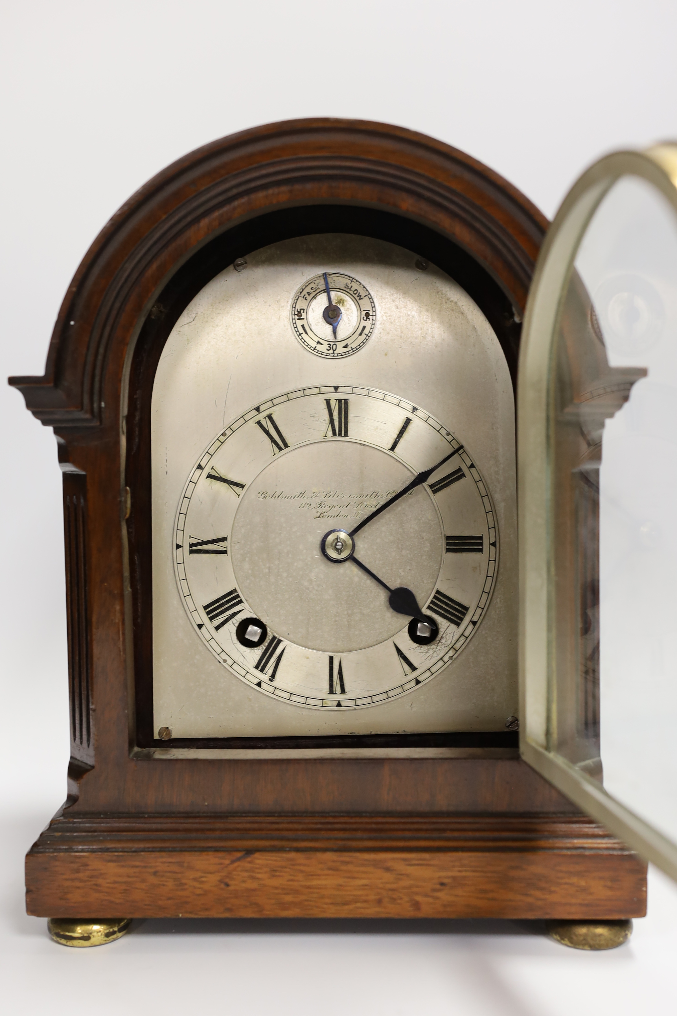 A mahogany mantel clock with silvered Roman numeral dial, 23cm high